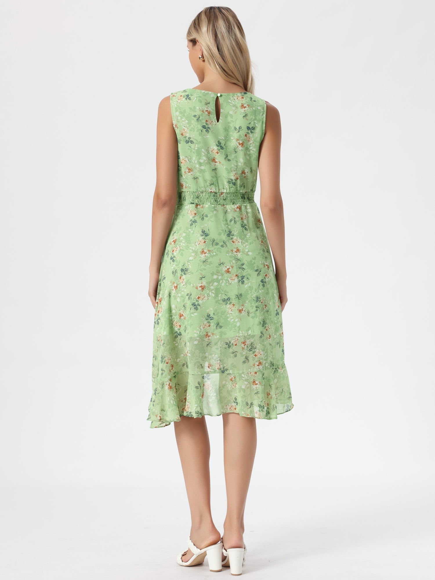 Green - Woman walking outdoors wearing a sleeveless floral chiffon midi sundress with an asymmetrical high-low ruffle hem.