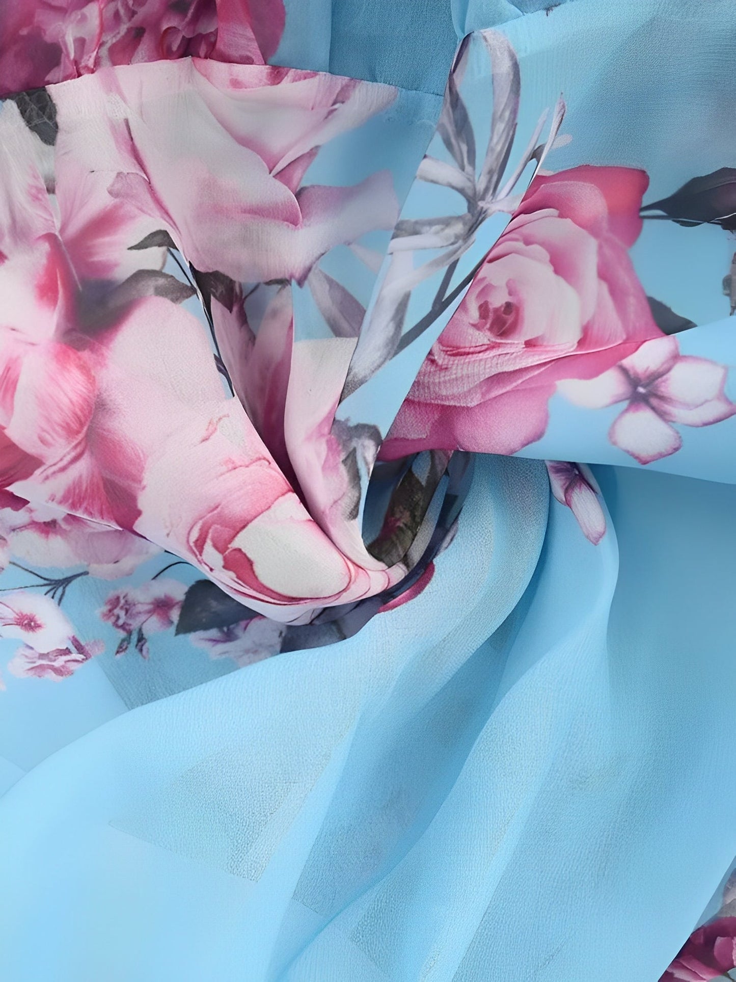 Light Blue - Woman wearing a floral print mini sundress with spaghetti straps, a large ruffle bodice overlay, and a tiered skirt