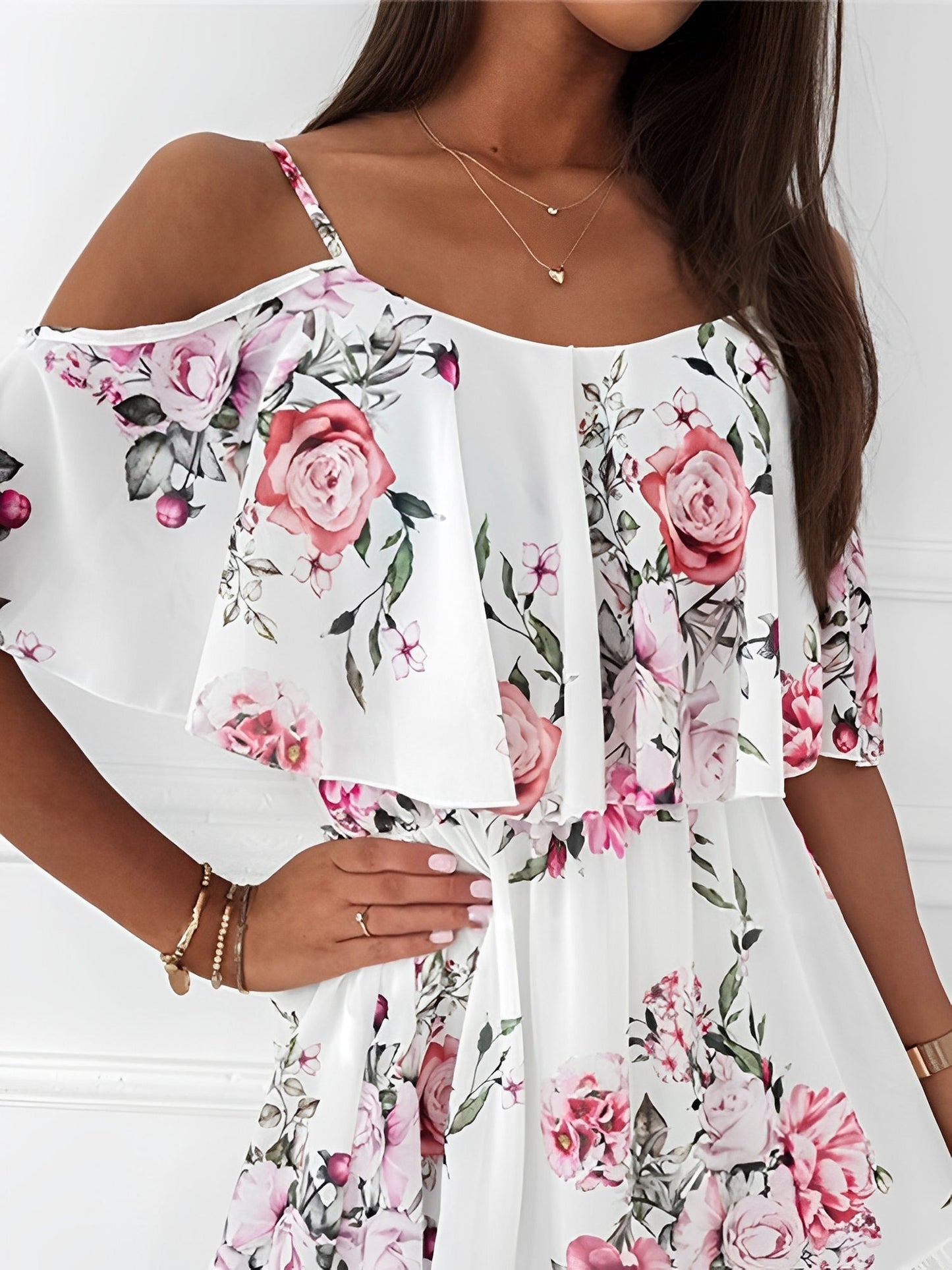 White - Woman wearing a floral print mini sundress with spaghetti straps, a large ruffle bodice overlay, and a tiered skirt