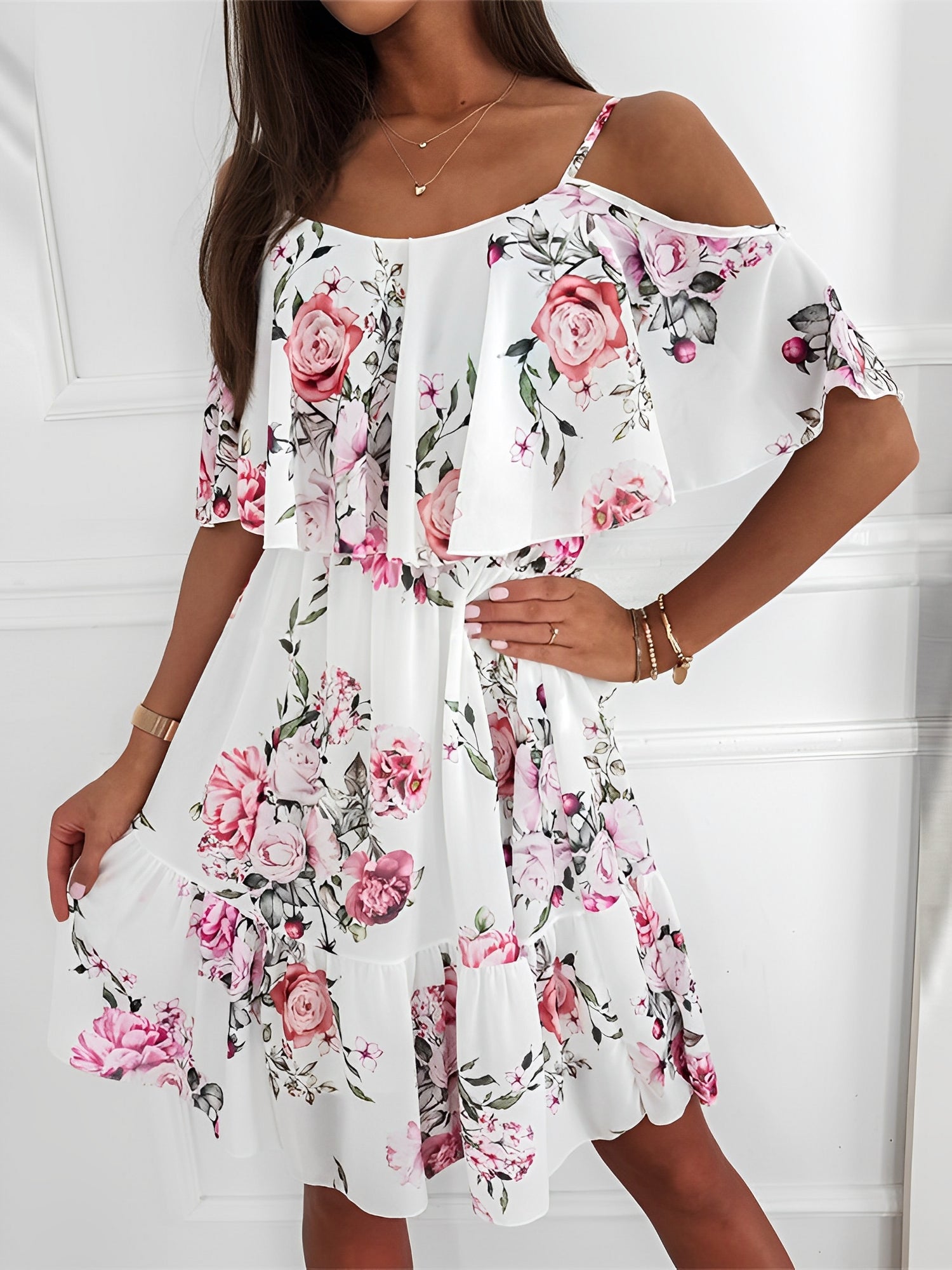 White - Woman wearing a floral print mini sundress with spaghetti straps, a large ruffle bodice overlay, and a tiered skirt