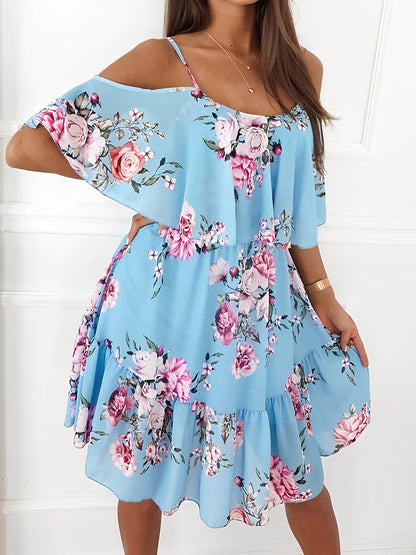 Light Blue - Woman wearing a floral print mini sundress with spaghetti straps, a large ruffle bodice overlay, and a tiered skirt