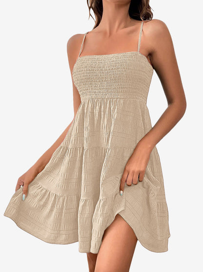 Beige - Woman wearing a textured smocked bodice mini dress with spaghetti straps and a tiered skirt