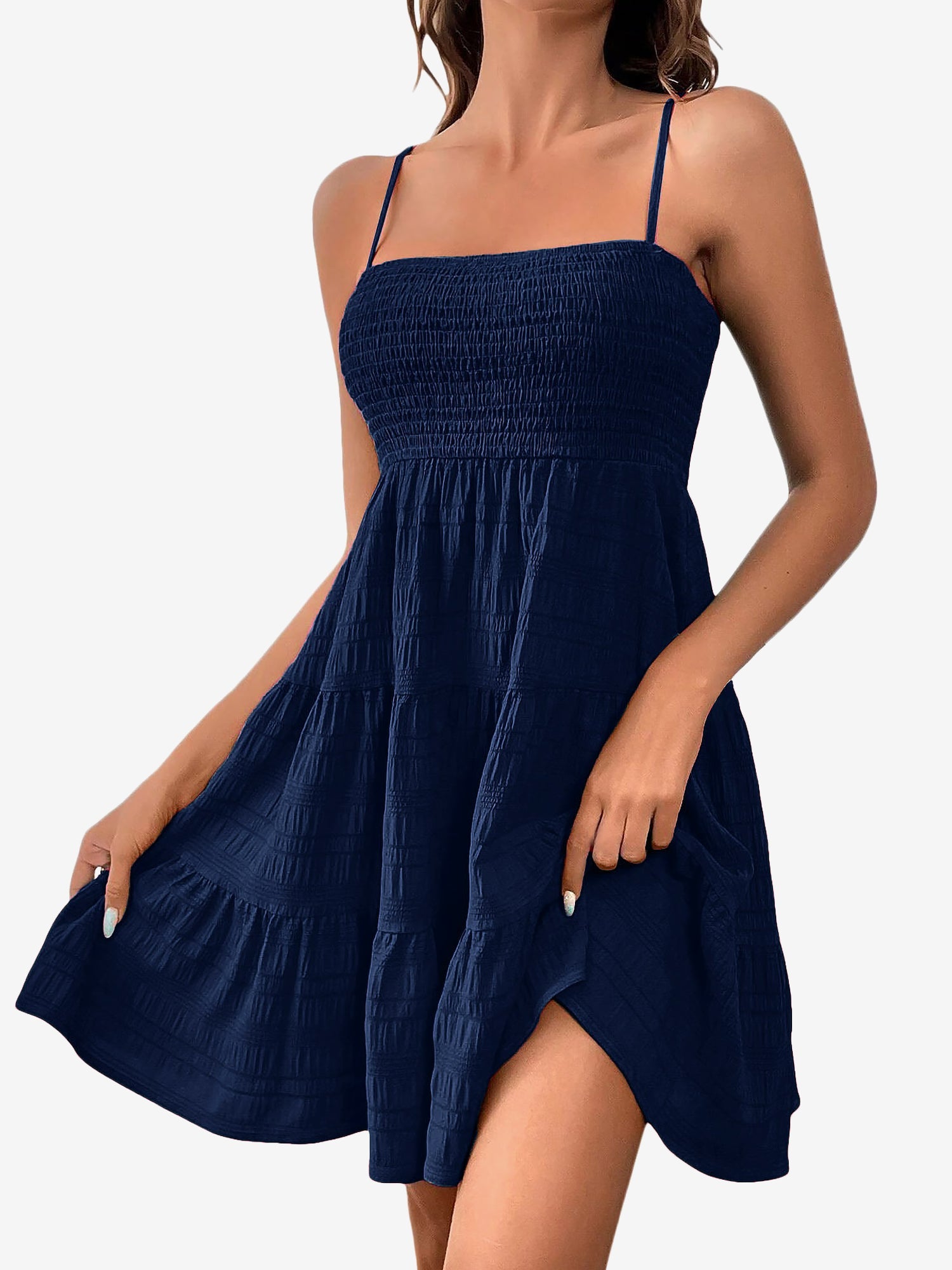 Navy Blue - Woman wearing a textured smocked bodice mini dress with spaghetti straps and a tiered skirt