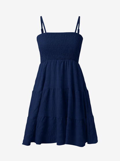 Navy Blue - Woman wearing a textured smocked bodice mini dress with spaghetti straps and a tiered skirt