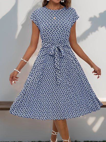 Navy Blue - Woman wearing a floral print midi dress featuring cap sleeves, a tie waist sash, and a finely pleated skirt.