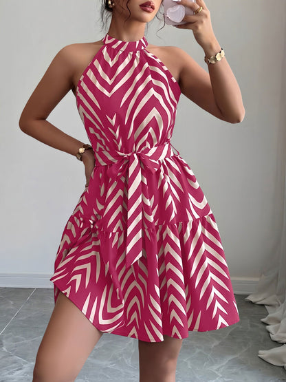 Rose Red - Woman wearing a sleeveless halter neck mini dress with a geometric pattern, featuring a tie waist and tiered skirt