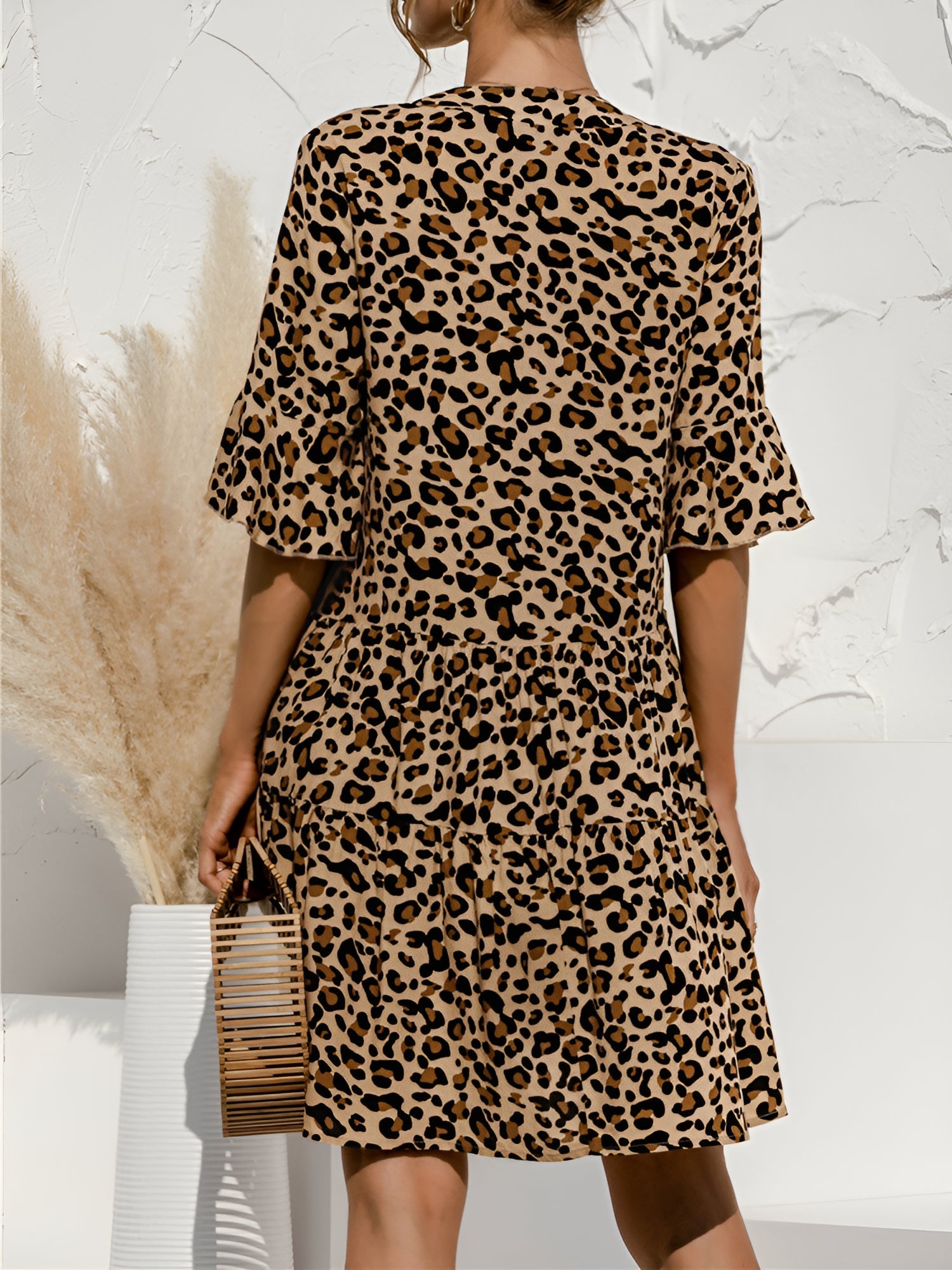 Leopard - Women's lightweight leopard print mini dress featuring a V-neckline with front ties, flared half sleeves, and a tiered skirt.