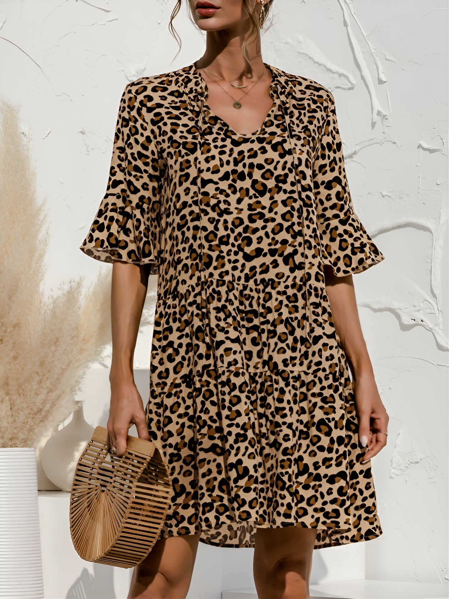 Leopard - Women's lightweight leopard print mini dress featuring a V-neckline with front ties, flared half sleeves, and a tiered skirt.