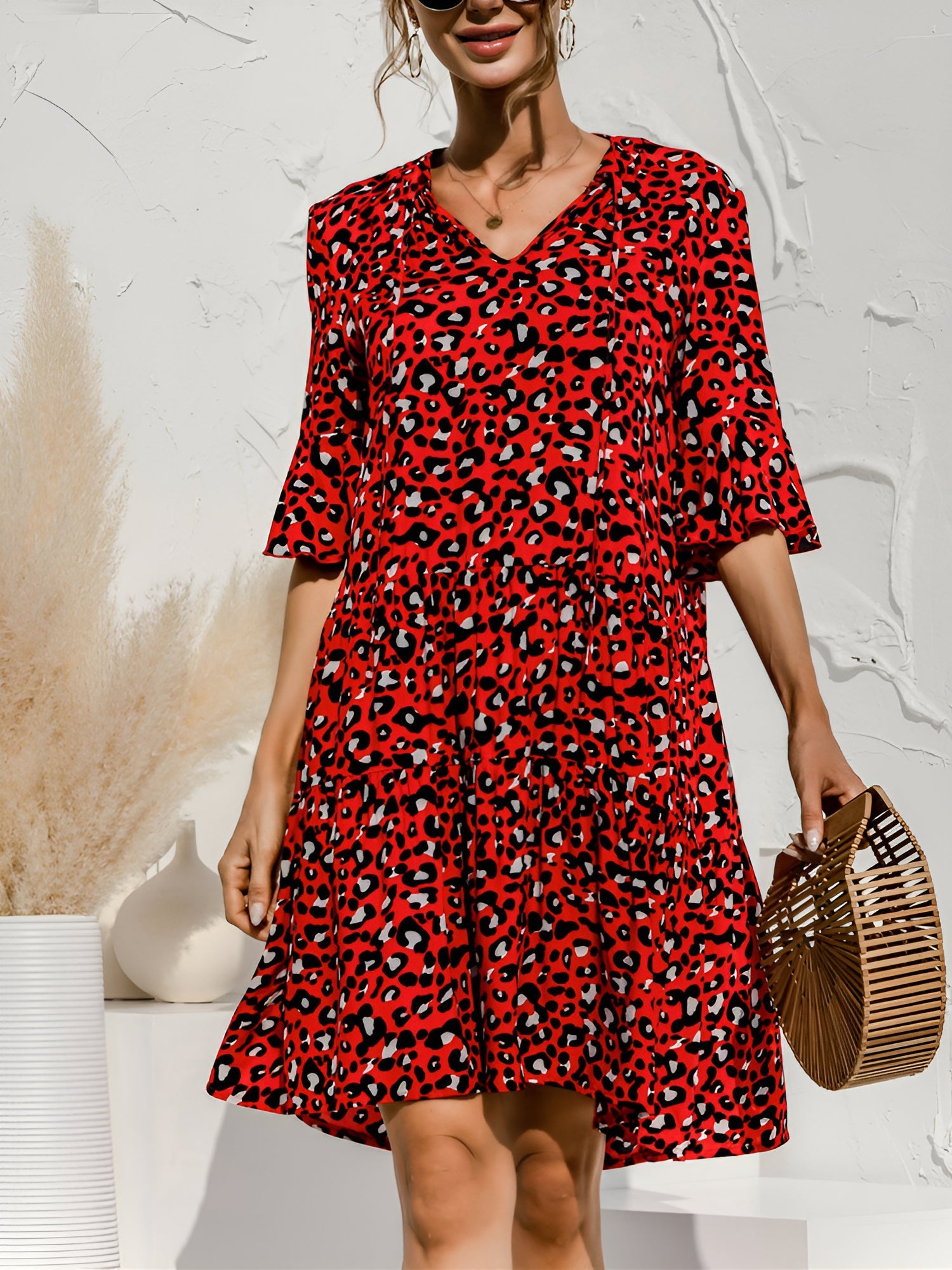 Red - Women's lightweight leopard print mini dress featuring a V-neckline with front ties, flared half sleeves, and a tiered skirt.