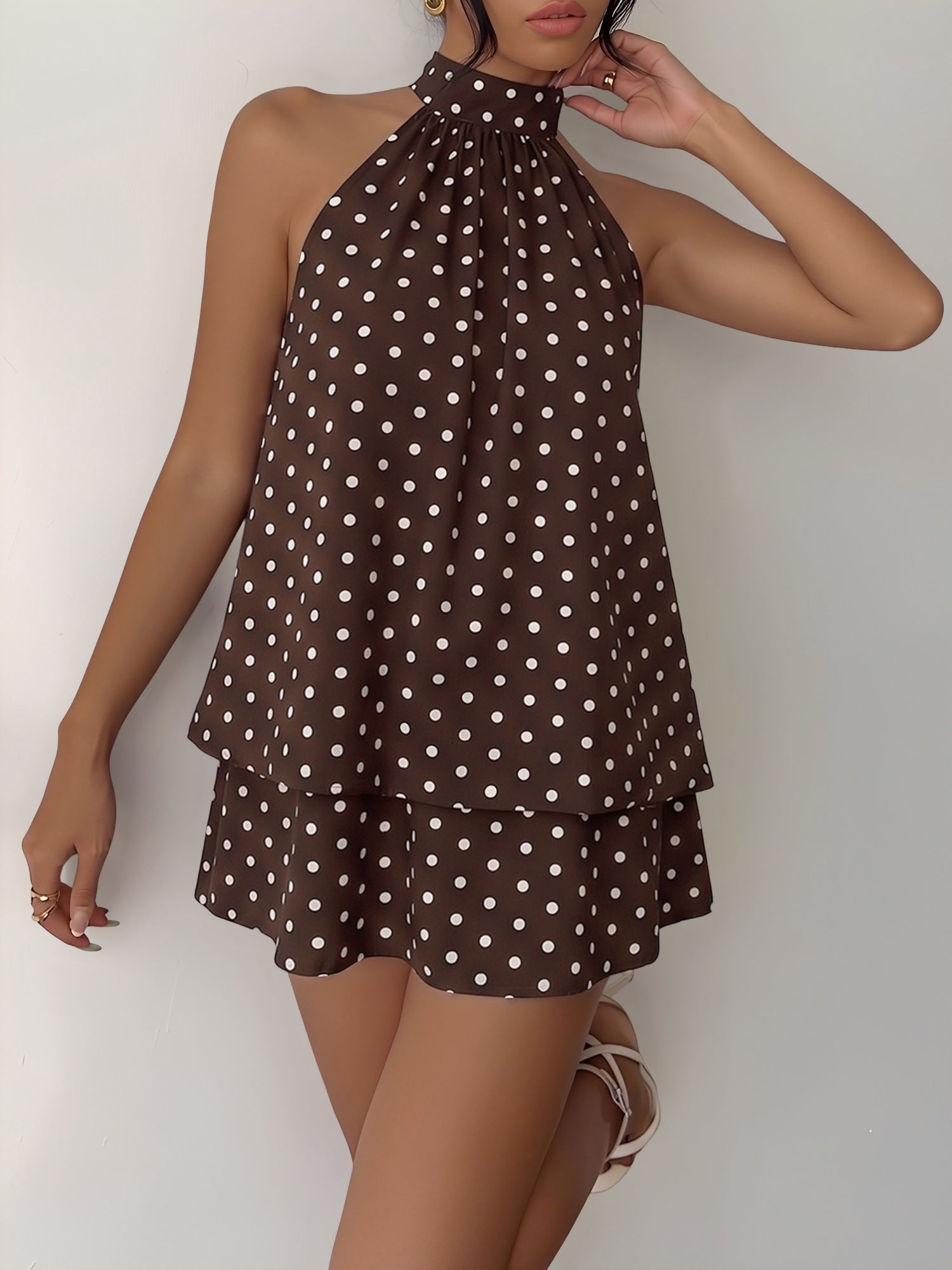 Coffee - Woman modeling a sleeveless halter neck mini dress with a polka dot print and blouson top