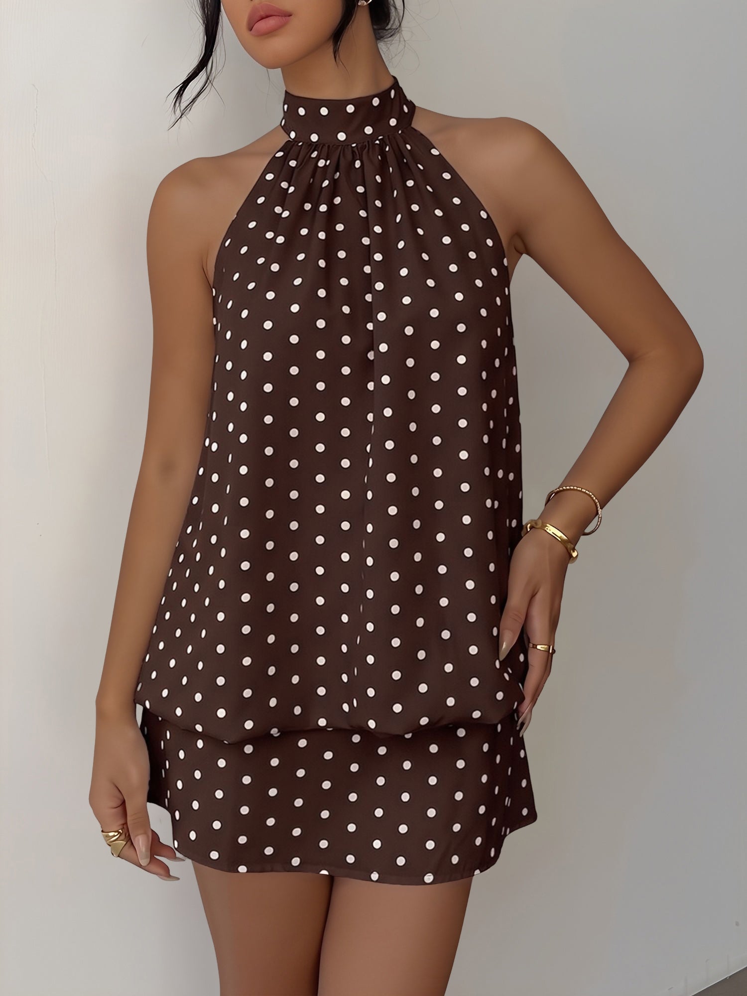 Coffee - Woman modeling a sleeveless halter neck mini dress with a polka dot print and blouson top