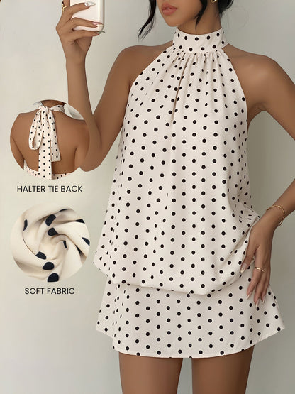Apricot - Woman modeling a sleeveless halter neck mini dress with a polka dot print and blouson top