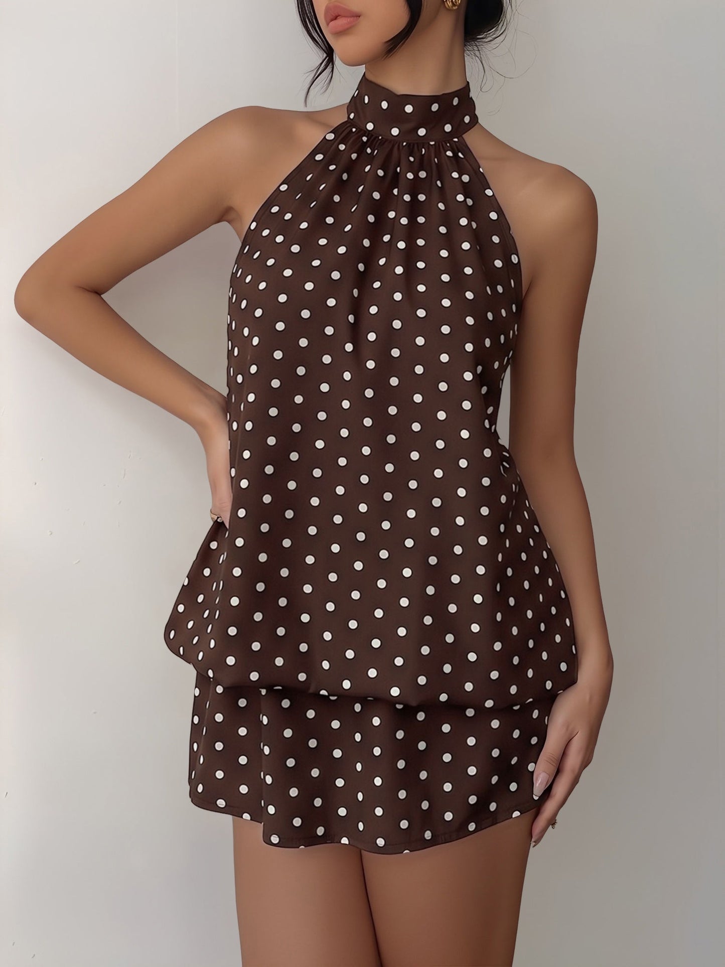 Coffee - Woman modeling a sleeveless halter neck mini dress with a polka dot print and blouson top