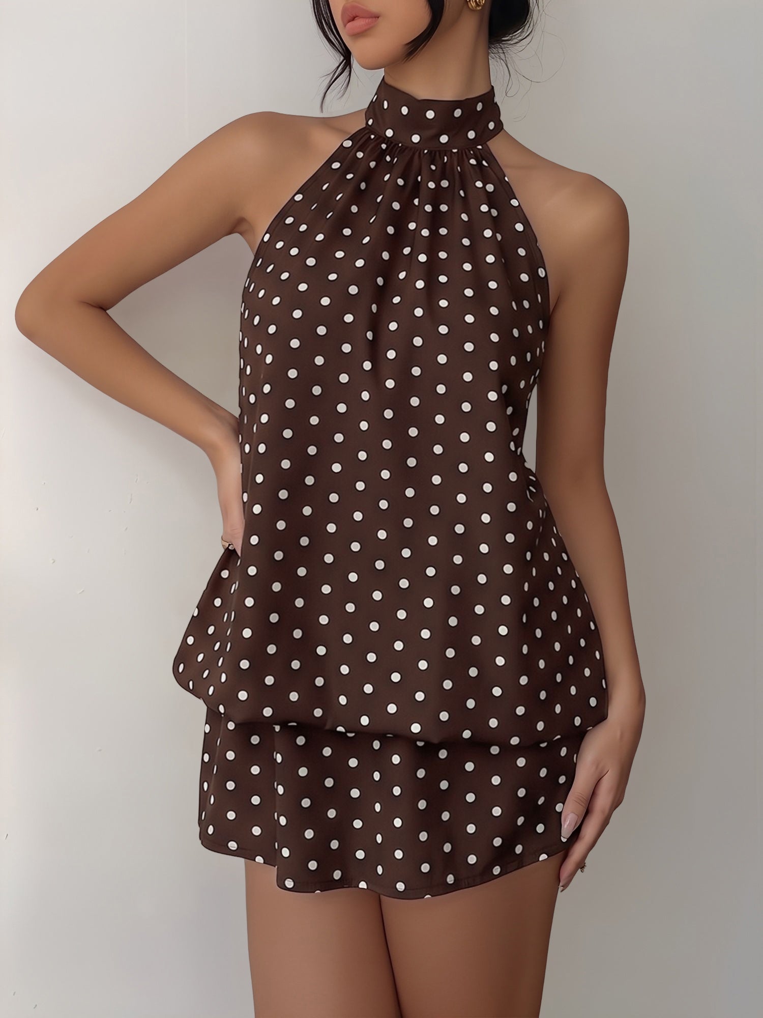 Coffee - Woman modeling a sleeveless halter neck mini dress with a polka dot print and blouson top