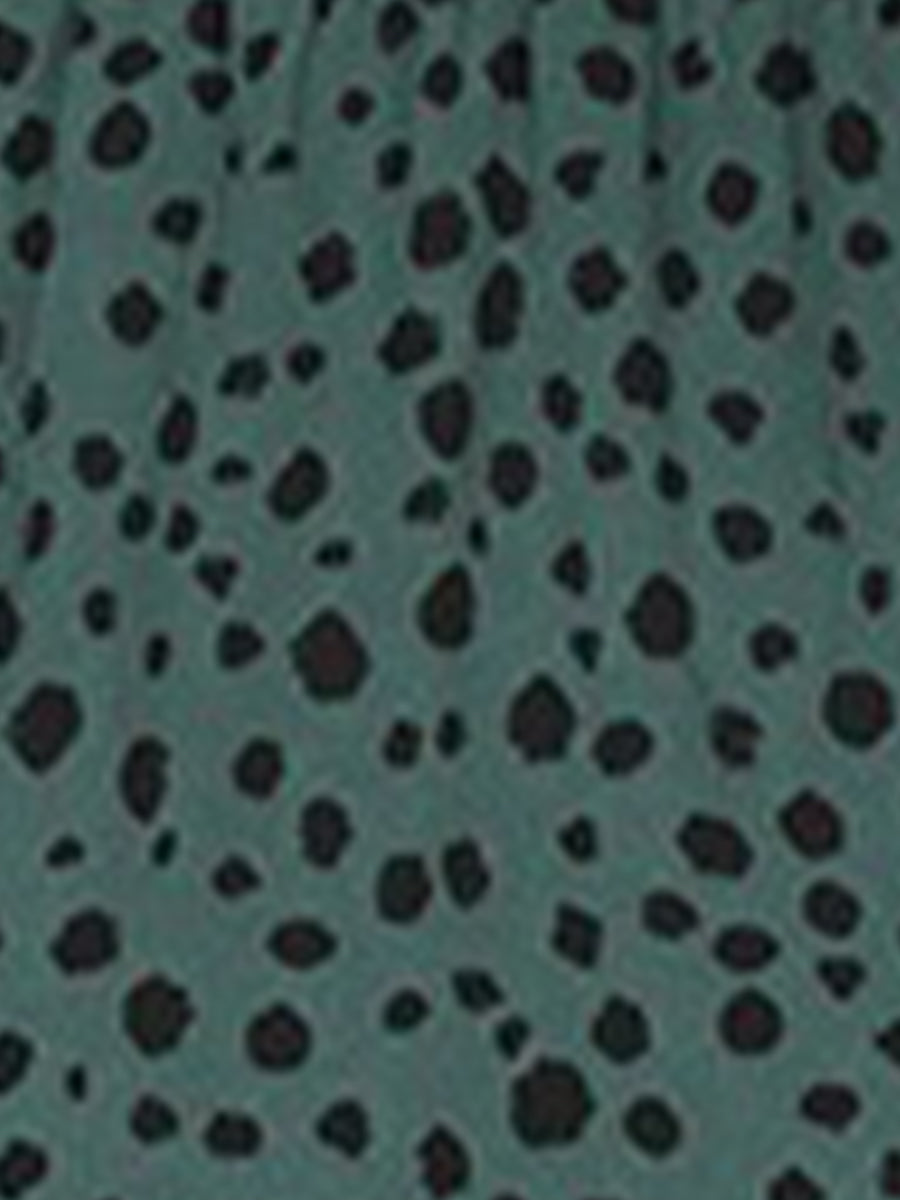 Dark Green - Woman wearing a polka dot V-neck midi dress with a tie waist and a tiered skirt featuring side pockets.