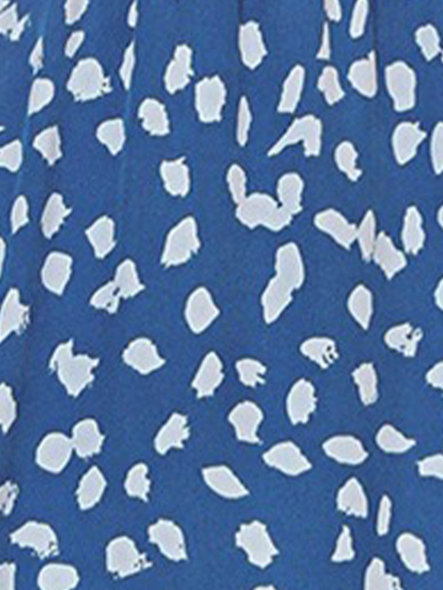 Blue - Woman wearing a polka dot V-neck midi dress with a tie waist and a tiered skirt featuring side pockets.