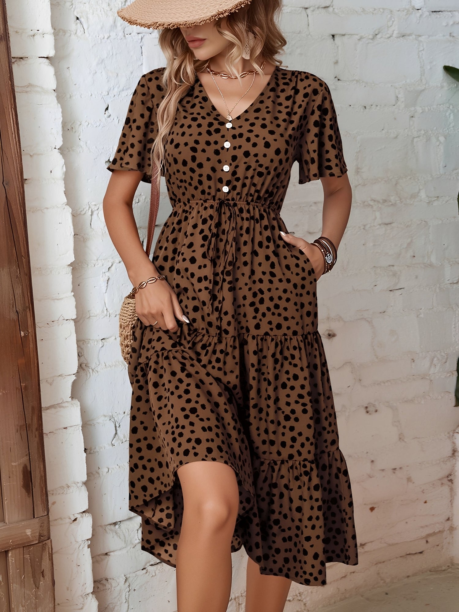 Leopard - Woman wearing a polka dot V-neck midi dress with a tie waist and a tiered skirt featuring side pockets.