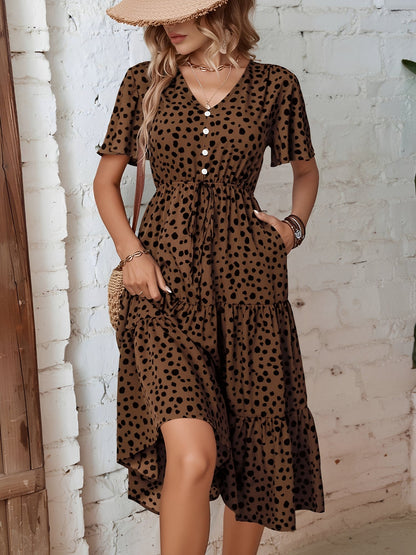 Leopard - Woman wearing a polka dot V-neck midi dress with a tie waist and a tiered skirt featuring side pockets.