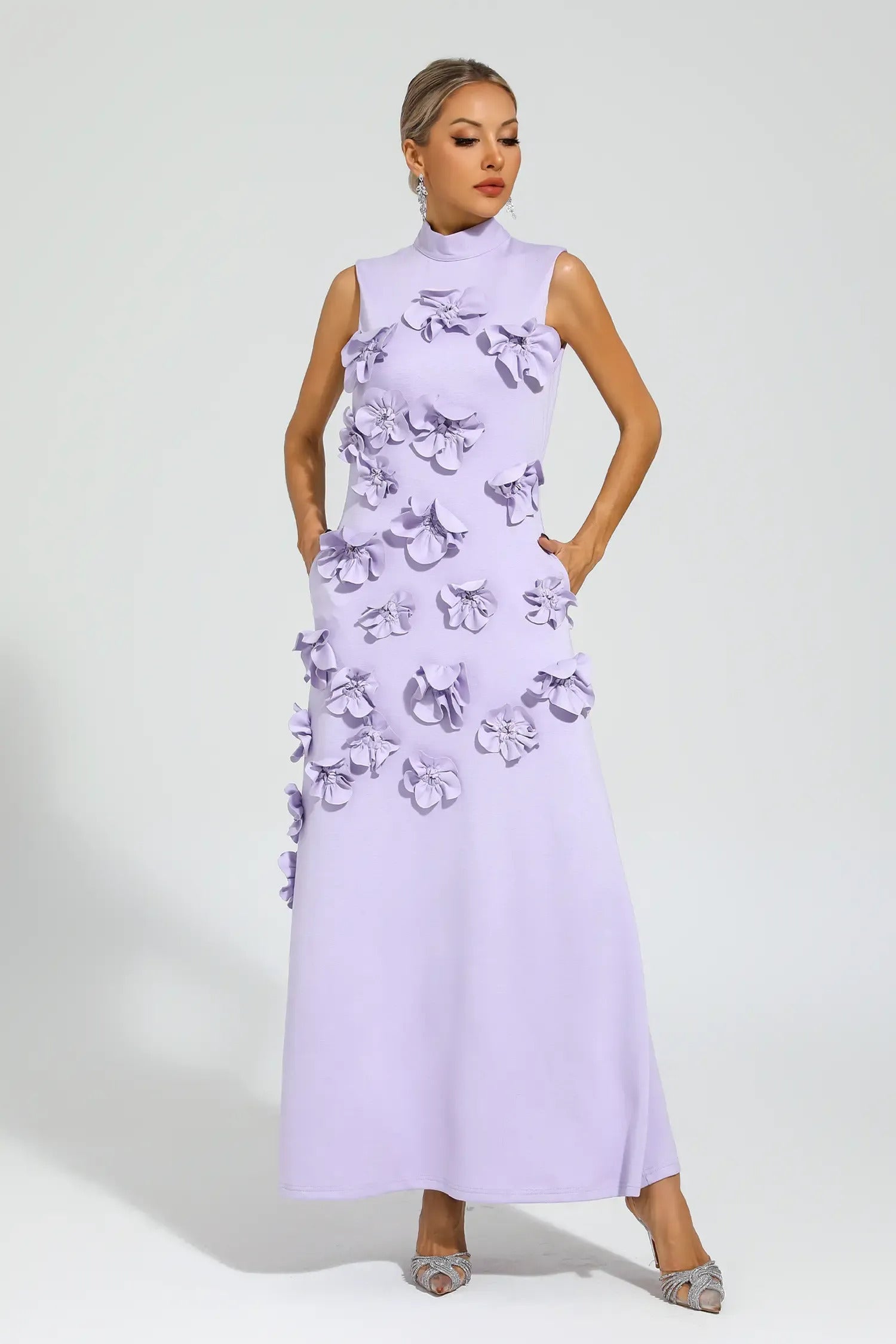 Purple - Sleeveless high neck maxi dress featuring a structured column silhouette and cascading dimensional floral appliques across the front bodice and skirt.