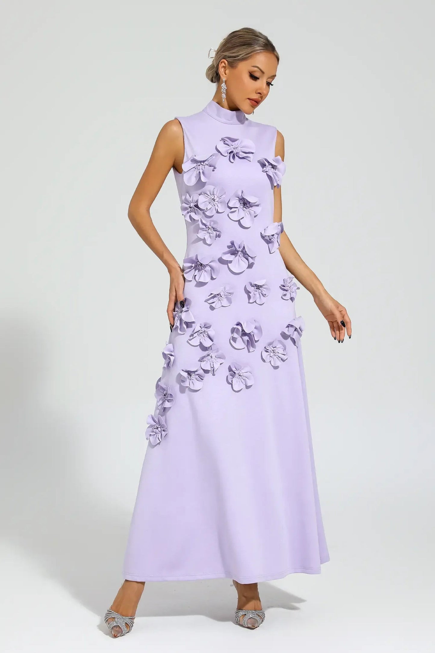 Purple - Sleeveless high neck maxi dress featuring a structured column silhouette and cascading dimensional floral appliques across the front bodice and skirt.