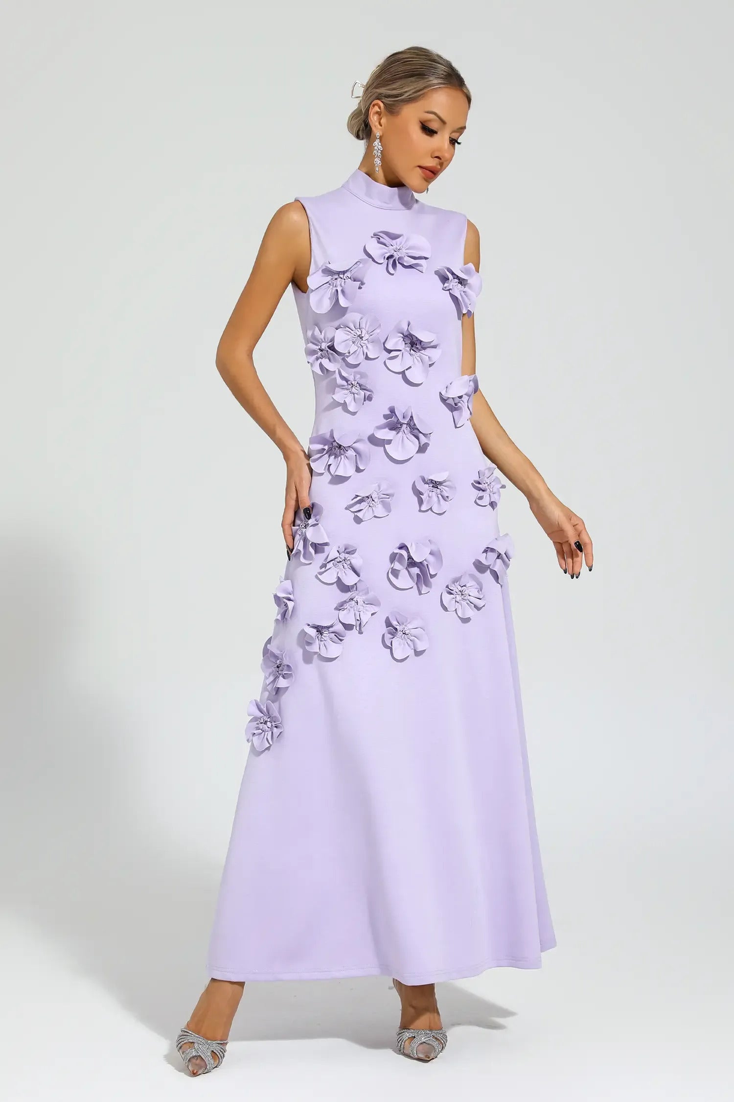 Purple - Sleeveless high neck maxi dress featuring a structured column silhouette and cascading dimensional floral appliques across the front bodice and skirt.