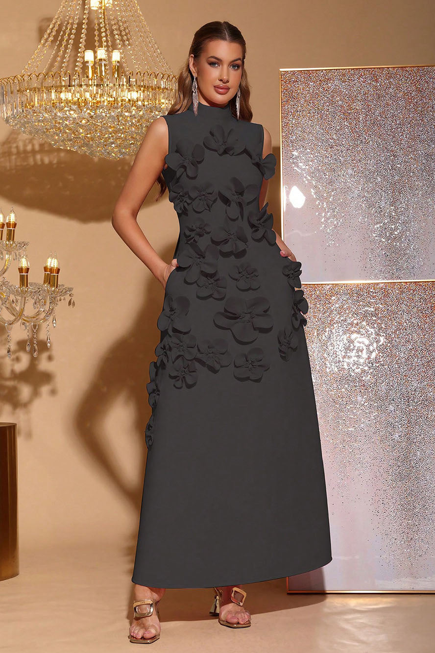 Black - Sleeveless high neck maxi dress featuring a structured column silhouette and cascading dimensional floral appliques across the front bodice and skirt.