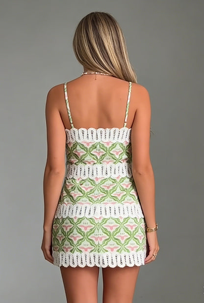 Women's mini A-line dress featuring a green and pink geometric floral print, delicate spaghetti straps, and horizontal white lace inserts, ending in a scalloped lace hem.