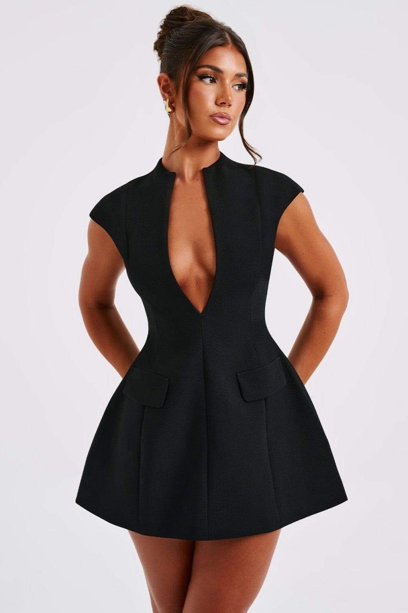 A woman models a black cap-sleeve mini blazer dress featuring a high collar, a deep plunging V-neckline, and a flared A-line skirt.