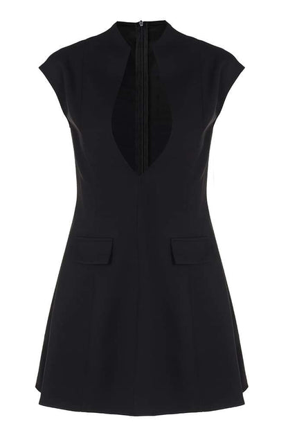 A woman models a black structured mini blazer dress featuring a high mock neck, a deep plunging keyhole cutout, extended cap sleeves, and a flared A-line skirt with flap pockets.