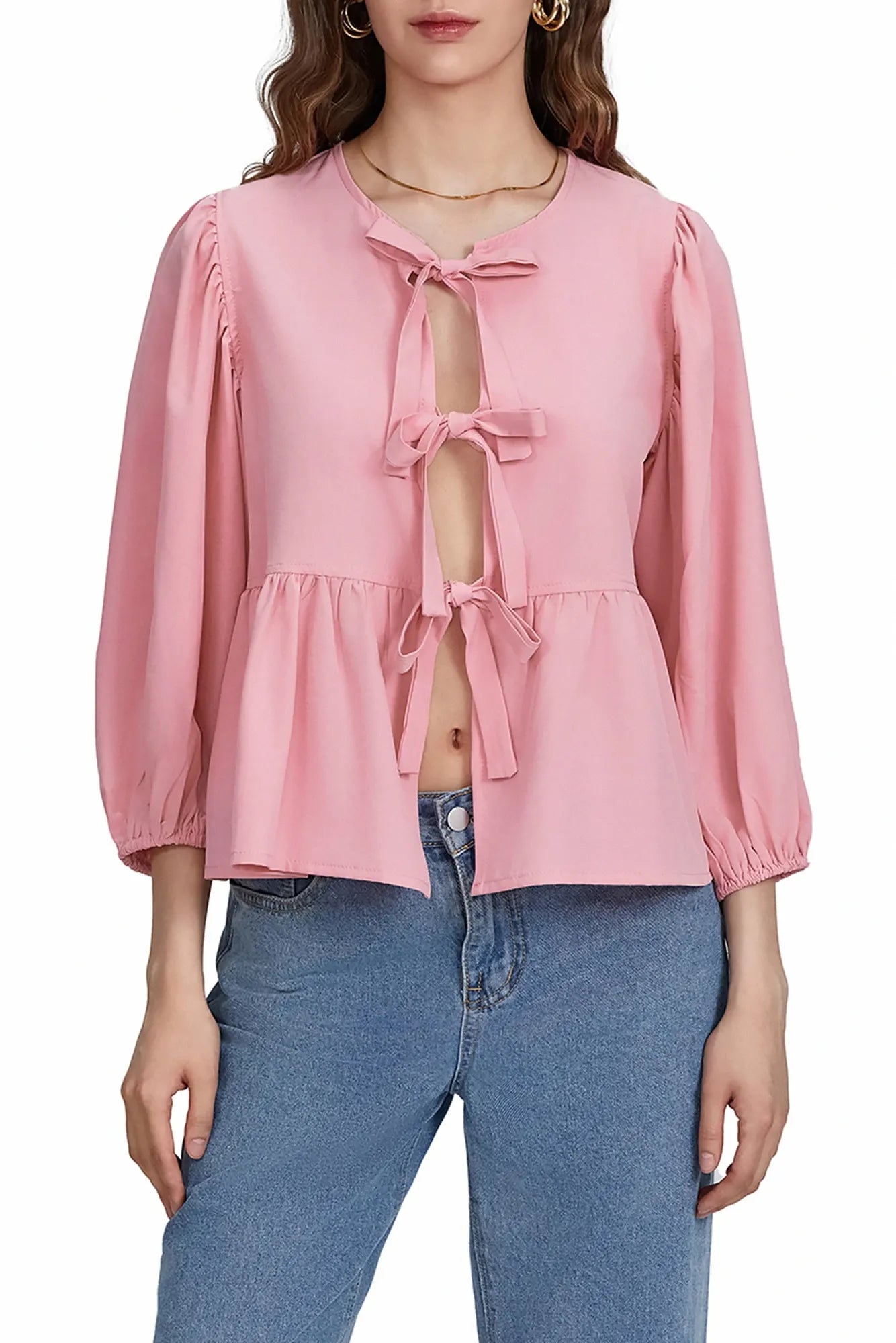 Woman wearing white cotton tie-front peplum blouse and jeans