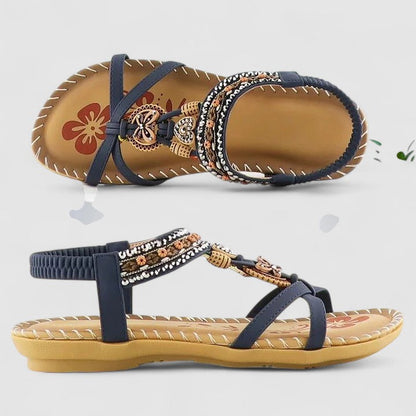 Cobalt Blue - Flat open-toe sandals featuring intricate beaded medallions, contrast stitching along the sole, and an elasticized slingback strap.