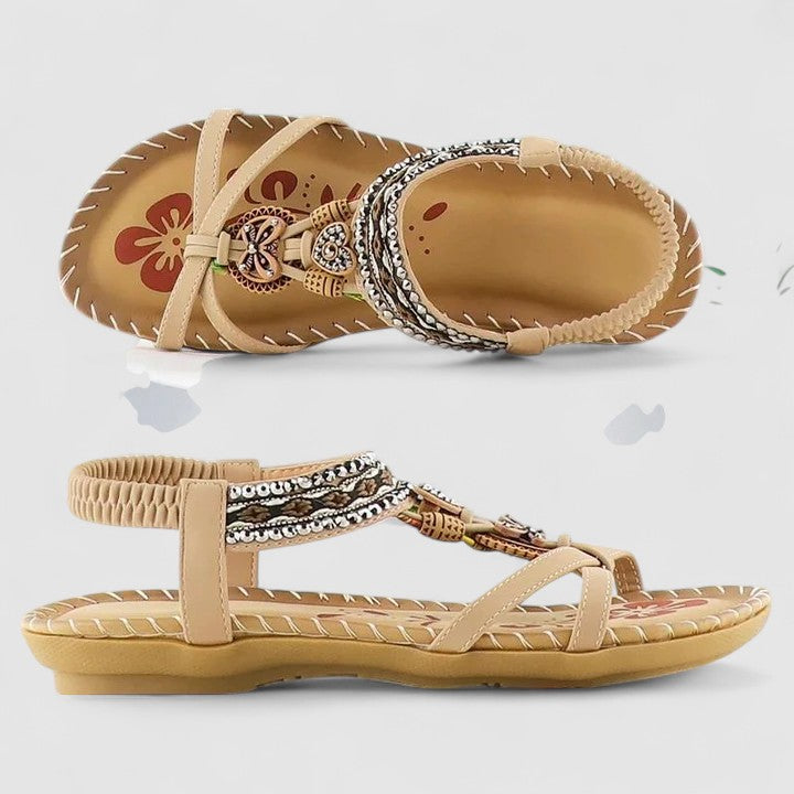 Mahogany Brown - Flat open-toe sandals featuring intricate beaded medallions, contrast stitching along the sole, and an elasticized slingback strap.
