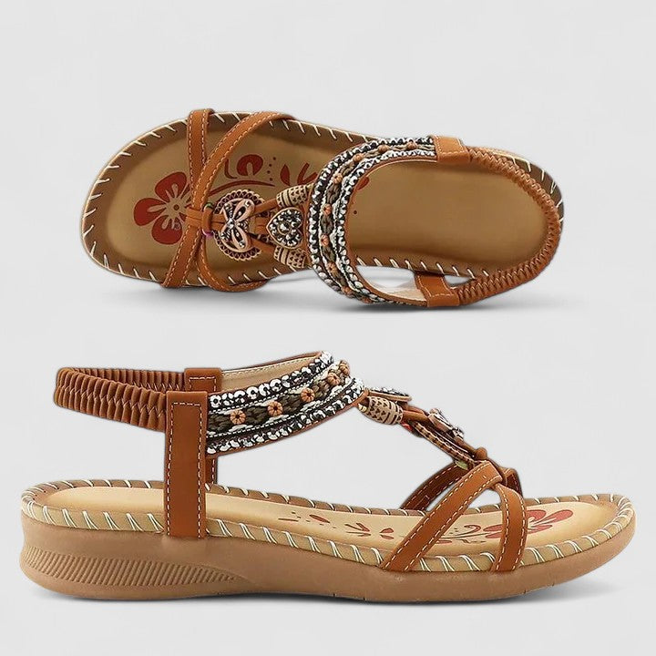 Beige Bali - Flat open-toe sandals featuring intricate beaded medallions, contrast stitching along the sole, and an elasticized slingback strap.