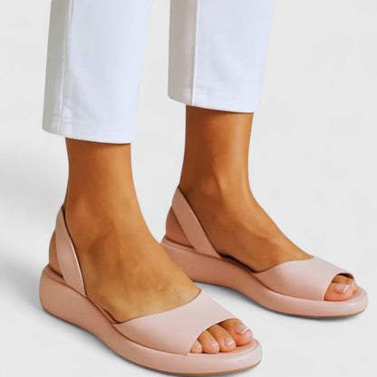 Pink - Faux-leather platform sandals featuring a wide front strap, open toe, and a continuous slingback strap on a thick cushioned sole.