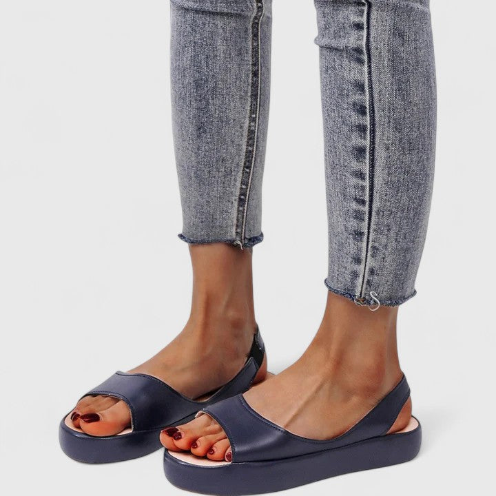 Pink - Faux-leather platform sandals featuring a wide front strap, open toe, and a continuous slingback strap on a thick cushioned sole.