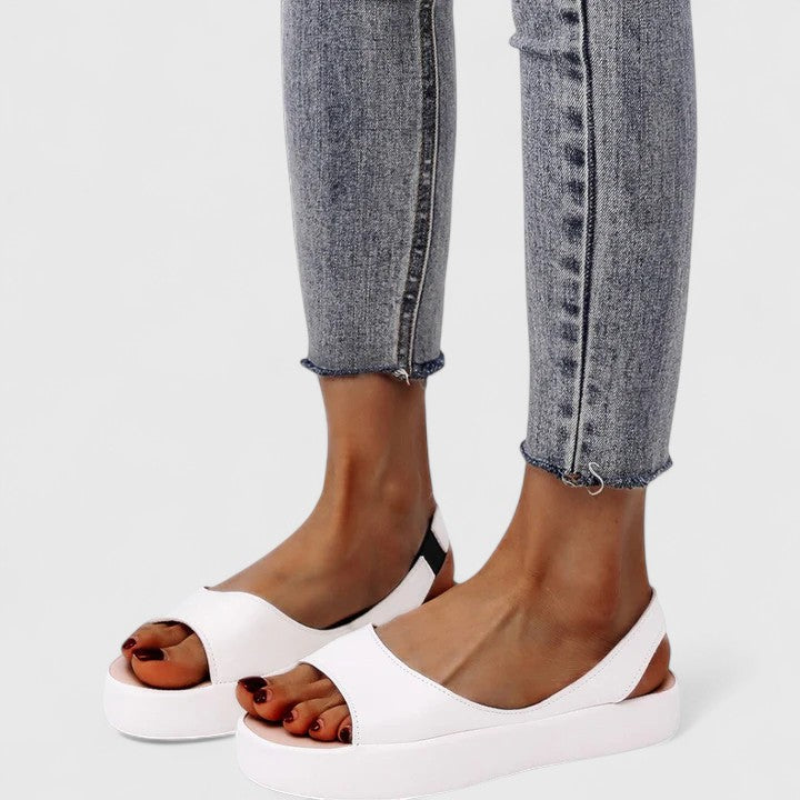 Pink - Faux-leather platform sandals featuring a wide front strap, open toe, and a continuous slingback strap on a thick cushioned sole.