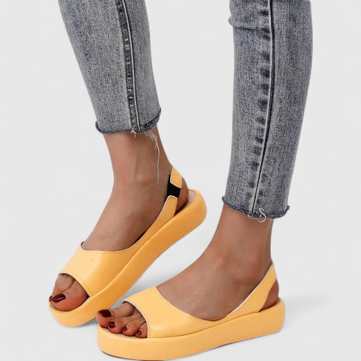 Pink - Faux-leather platform sandals featuring a wide front strap, open toe, and a continuous slingback strap on a thick cushioned sole.