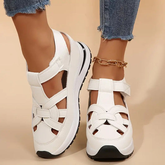 White - Women's faux-leather orthopedic platform sandals featuring a woven cut-out upper design, adjustable heel strap, and thick cushioned sole, modeled on feet.