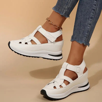 White - Women's faux-leather orthopedic platform sandals featuring a woven cut-out upper design, adjustable heel strap, and thick cushioned sole, modeled on feet.