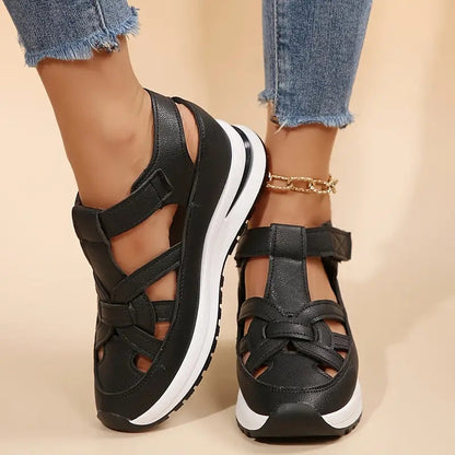 Black - Women's faux-leather orthopedic platform sandals featuring a woven cut-out upper design, adjustable heel strap, and thick cushioned sole, modeled on feet.