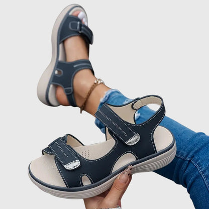 Black - Women's faux-leather platform sandals featuring dual hook-and-loop adjustable straps, contrast stitching details, and a thick shock-absorbing sole.