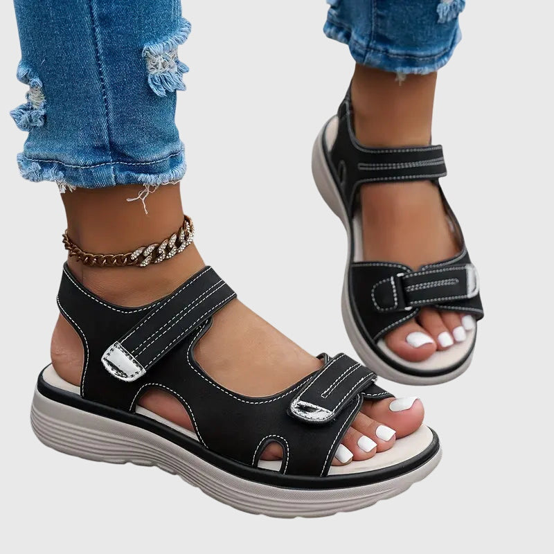 Black - Women's faux-leather platform sandals featuring dual hook-and-loop adjustable straps, contrast stitching details, and a thick shock-absorbing sole.