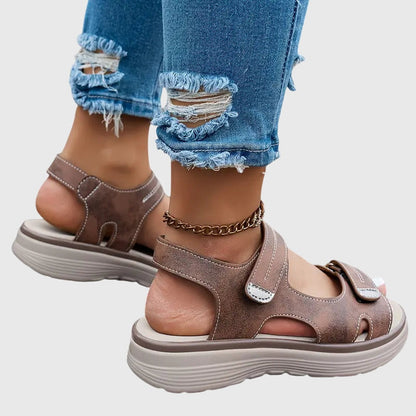 Black - Women's faux-leather platform sandals featuring dual hook-and-loop adjustable straps, contrast stitching details, and a thick shock-absorbing sole.