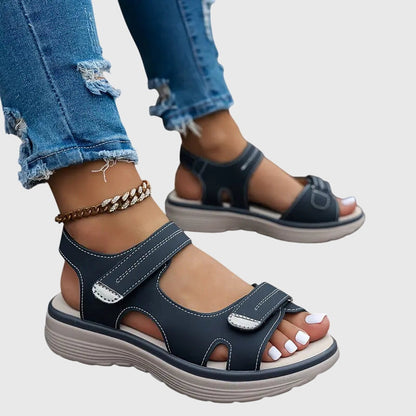 Black - Women's faux-leather platform sandals featuring dual hook-and-loop adjustable straps, contrast stitching details, and a thick shock-absorbing sole.