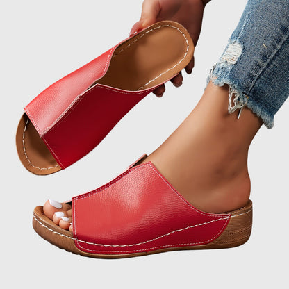 Black - Women's faux-leather slip-on wedge sandals featuring an open-toe design, contoured footbed, and detailed contrast stitching along the sole.
