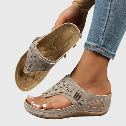 Khaki - Faux-leather wedge sandals featuring a slip-on thong design, laser-cut upper detailing, decorative metallic buckle, and prominent contrast stitching along a thick shock-absorbing sole.