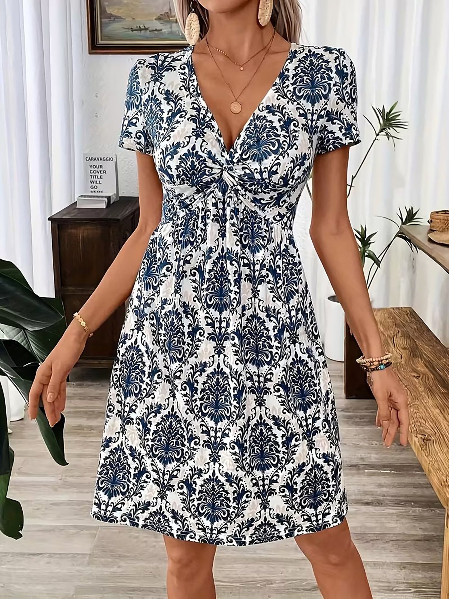 Blue - Woman wearing a short sleeve leopard print mini dress with a V-neckline and twist detail at the bust.