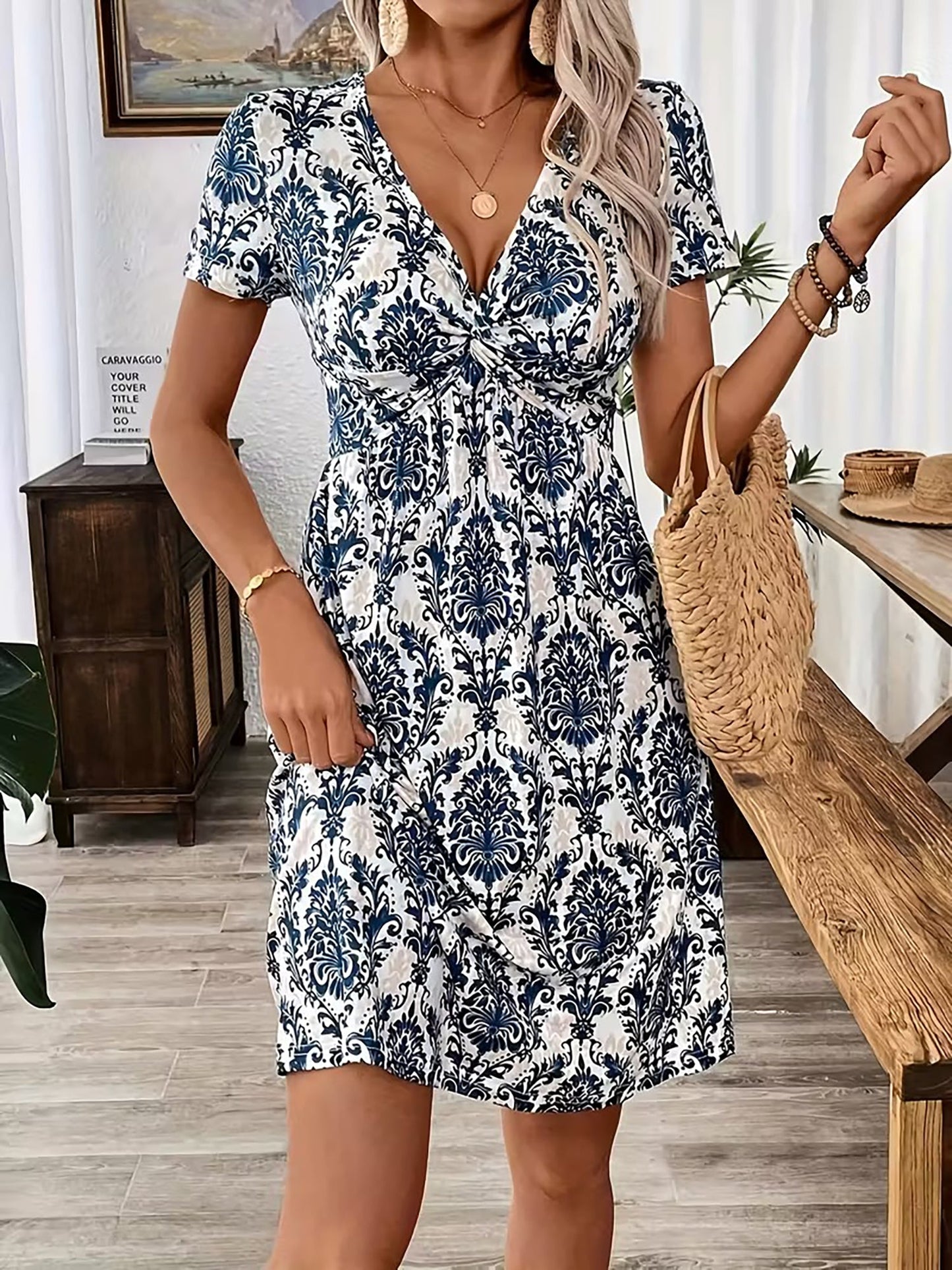 Blue - Woman wearing a short sleeve leopard print mini dress with a V-neckline and twist detail at the bust.