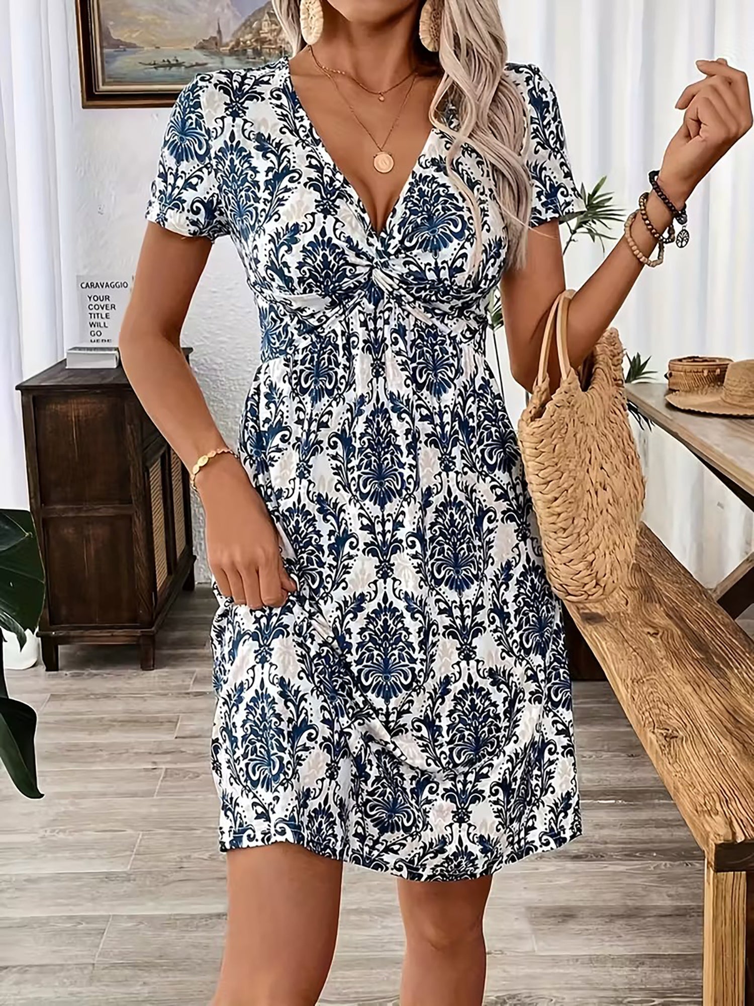 Blue - Woman wearing a short sleeve leopard print mini dress with a V-neckline and twist detail at the bust.