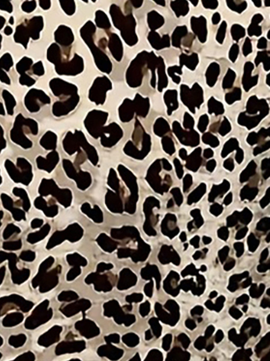 Leopard - Woman wearing a short sleeve leopard print mini dress with a V-neckline and twist detail at the bust.